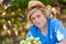 Smiling blond boy in hat harvesting ripe grapes