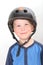 Smiling blond boy wearing black skate helmet