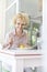 Smiling blond customer eating lunch at table in restaurant