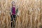 Smiling blond girl in cornfield