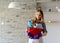 Smiling blond woman holding a bucket full of cleaners