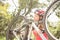 Smiling blonde athlete checking her mountain bike