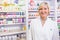 Smiling blonde pharmacist posing in lab coat