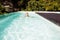 Smiling blonde swimming in the pool