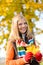 Smiling blonde teen girl autumn forest leaves