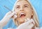 Smiling blonde woman examined by dentist at dental clinic. Healthy teeth and medicine concept