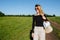 Smiling blonde woman with long hair standing on a track in the middle of nowhere