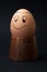 Smiling boiled egg on the wooden egg holder