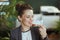 smiling bookkeeper woman in green office eating salad