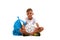 A smiling boy with a ball and a blue bag sitting in a yoga pose. Happy child isolated on a white background. Sports