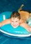 A smiling boy is bathing in the water. Sports and recreation. Wonderful people. Close-up