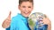 Smiling boy in casual holding planet earth with thumbs up