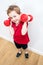 Smiling boy expressing fun pride, lifting dumbbells to grow up