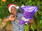 Smiling boy with Father Christmas hat opening present