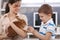 Smiling boy feeding rabbit