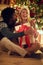 Smiling boy and girl exchanging Christmas presents