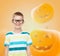 Smiling boy in glasses over pumpkins background