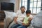 Smiling boy with grandfather using digital tablet while sitting at home