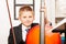 Smiling boy holding fiddlestick, play violoncello