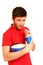 Smiling boy holding popcorn and drinking from cup isolated on white background