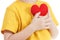 Smiling boy holding a red heart figurine. symbol of love, family, . Concept of the family and children.