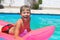 Smiling boy lies on pink mattress