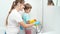 Smiling boy with mother washing bath and water sink. Children helping adults in housework and home cleanup.