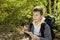 Smiling boy orienteering in forest