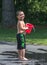 Smiling boy plays with buckets of water outdoors