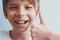 Smiling boy showing thumbs up. Emotion concept