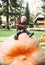 Smiling boy sits on huge size pumpkin