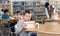 Smiling boy sitting with pile of textbooks