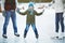 Smiling boy skating with parents