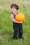 Smiling boy standing with pumpkin