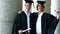 Smiling boys holding their diplomas