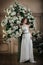 Smiling bride near the tree with white flowers.