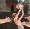 Smiling bride tossing a bouquet for her good friends