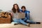 Smiling brother and sister using laptop at home