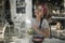 Smiling brunette girl in a red bandana and with plait having a tropical lunch in open cafe, green cocktail and bowl with