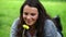 Smiling brunette smelling a yellow flower