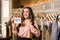 Smiling brunette woman holds new collection sign.