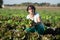 Smiling brunette woman picking lettuce salads