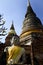 Smiling buddha sitting beside ayutthaia ruins