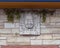 Smiling Buddha stone relief outside the Cosmic Cafe on Oak Lawn in Dallas, Texas.