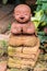 Smiling buddhist novice made of clay, Thai style