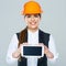 Smiling builder business woman showing tablet PC with yours info