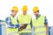 Smiling builders in hardhats with tablet pc