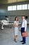 Smiling Business Couple in Airport Hangar