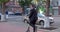 Smiling business man in suit riding an electric scooter on business meeting. in city