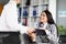 Smiling business woman signing document, employee give agreement paper to boss lady